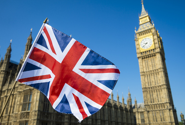 The flag of the United Kingdom in front of the Palace of Westminster 