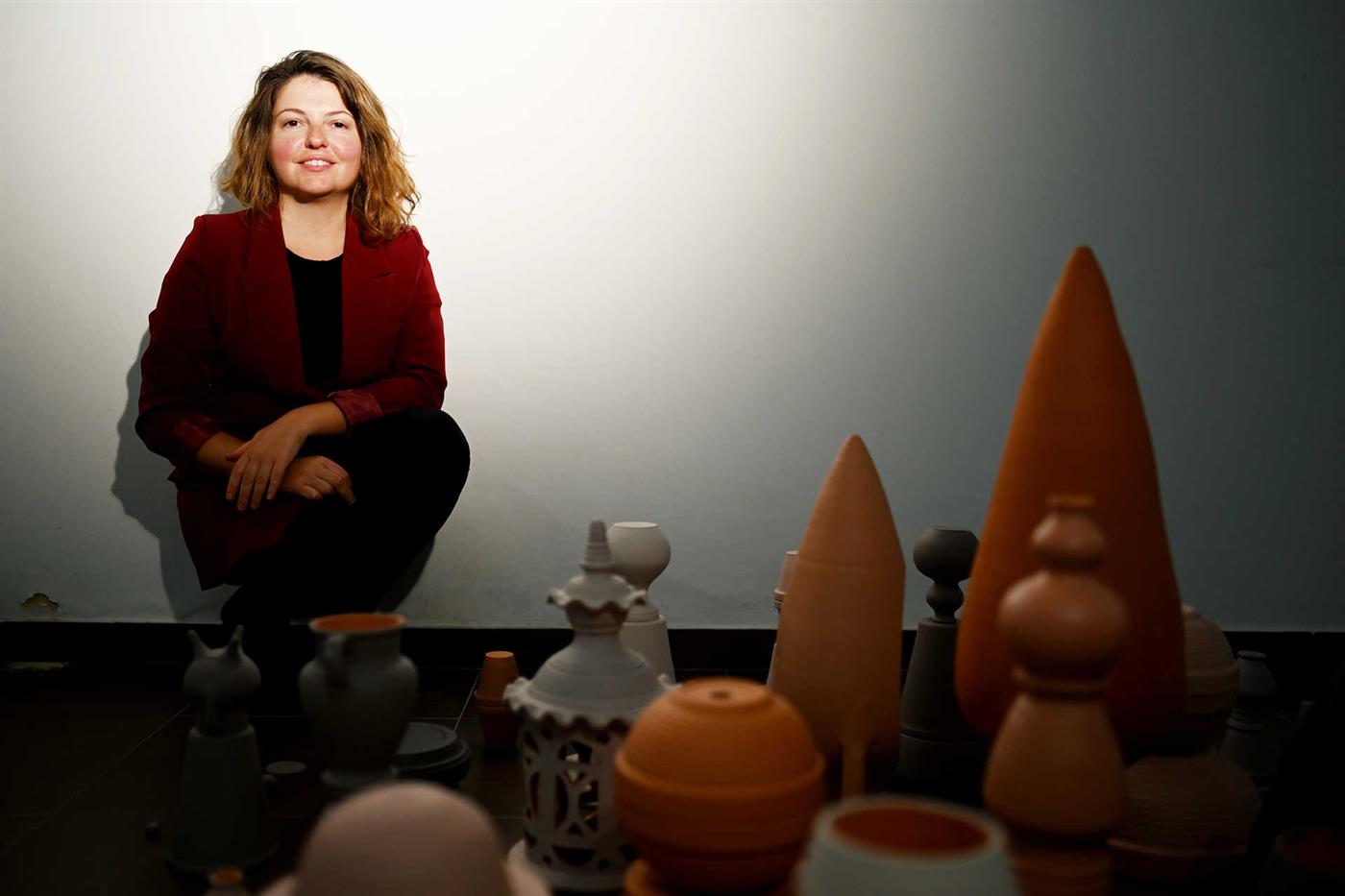 Özge Topçu poses with one of his works in his studio at Campo de Ourique.