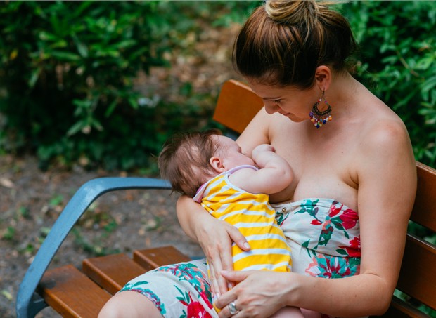 A mother breast-feeds her baby in the garden (Image: Getty Images)