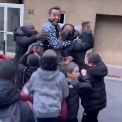 Children celebrate with Nene for a “great goal” at a window in Paris