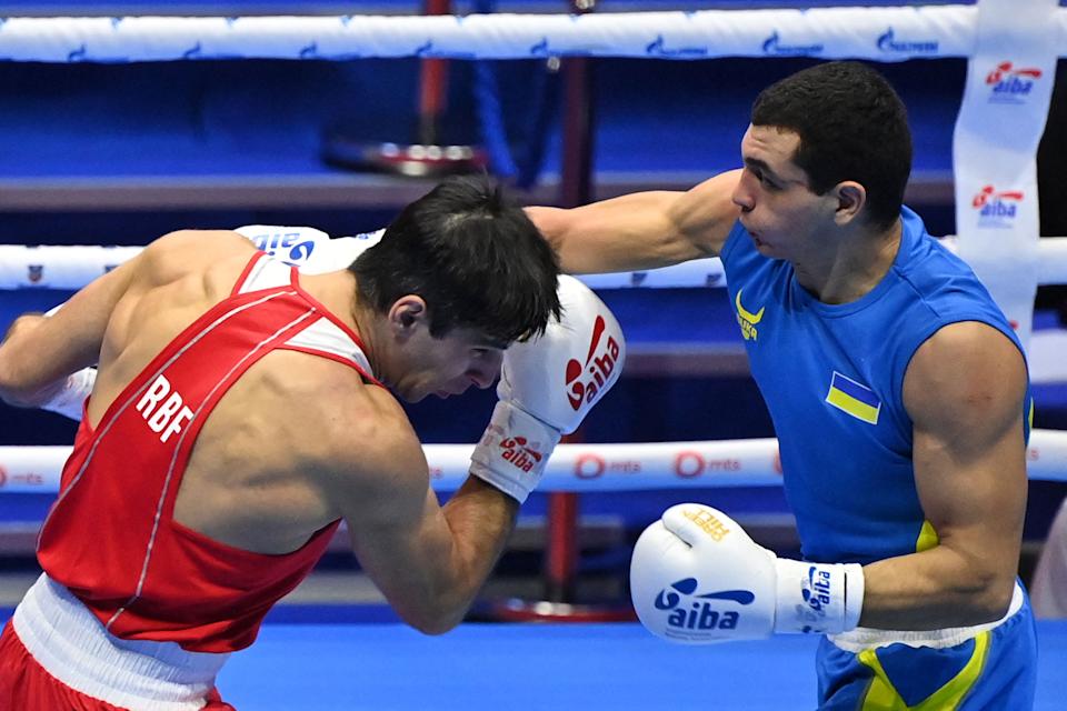 Russia's Vadim Musaev (red) fights against Ukraine's Yuri Zakharyev (blue) in the men's lightweight during the finals of the AIBA Men's Boxing World Championships, in Belgrade, on November 6, 2021 (Photo by ANDREJ ISAKOVIC / AFP) (Photo by ANDREJ ISAKOVIC / AFP) via Getty Images)