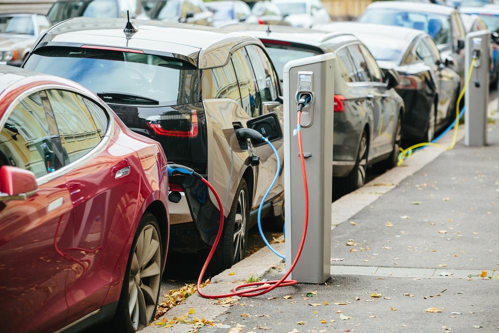 The electric car is recharged at a station on the street