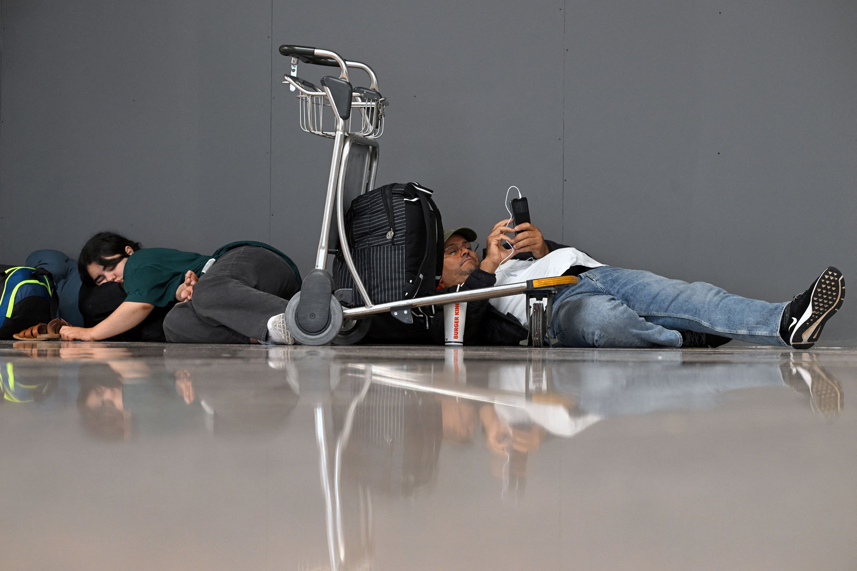 Passengers affected by Ryanair's strike wait to change their ticket at the airport