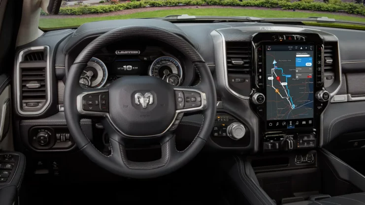 Interior of a Dodge car with steering wheel and instrument panel with digital display.