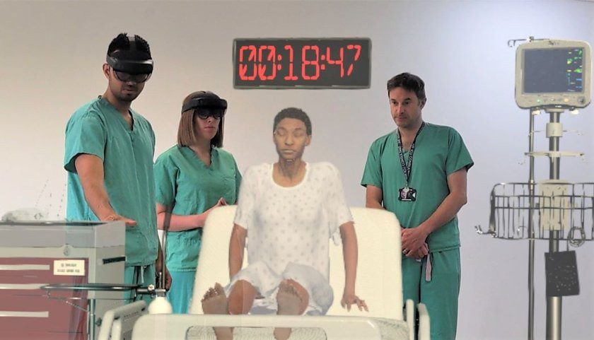 Student Aniket Bharadwaj with trainers Dr.  Ruby Woodard (left) and Dr.  Jonny Martin (right), identifying a patient with a hologram (Photo: Background/Cambridge University Hospitals)