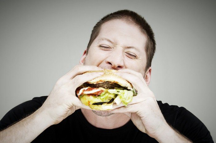 Man eating a hamburger - Metropolis